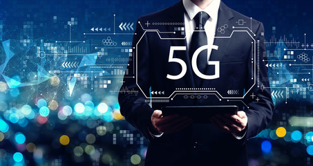 5G network with businessman holding a tablet computer