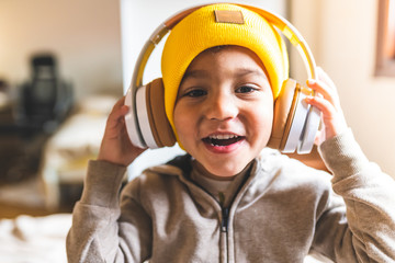 Close Up of Latin American Boy Listening Music on Headphones.