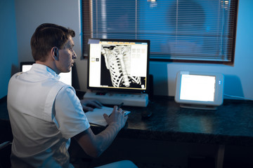 in the Medical Laboratory the Radiologist in the Control room Monitors the Skeleton and ribs of the...