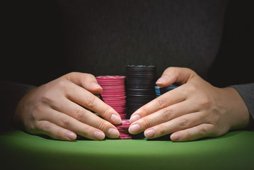 Woman hands and poker chips close up.