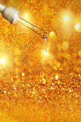 Pipette with drop of serum or hyaluronic acid on sparkling gold background.