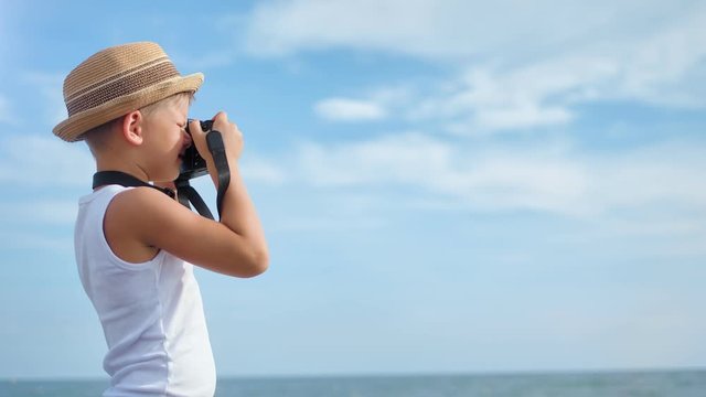 Tourist little kid making picture of natural beach landscape use photographic equipment