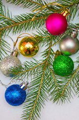 Background with multi-colored  Christmas ball in the branches of the Christmas tree, New Year decorations