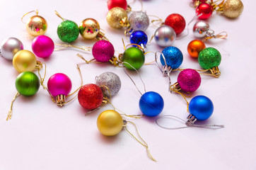 colorful christmas decorations scattered on a white background, preparation for decorating the Christmas tree