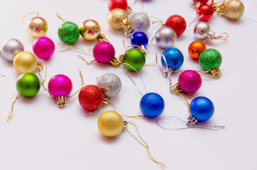 colorful christmas decorations scattered on a white background, preparation for decorating the Christmas tree