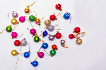 colorful christmas decorations scattered on a white background, preparation for decorating the Christmas tree