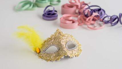 Golden carnival mask close-up on white background