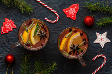 Hot tea with orange slices, cranberries and rosemary