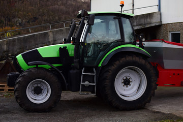 A tractor stands at the farm. Farms of Northern Europe.
