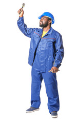 African-American car mechanic on white background