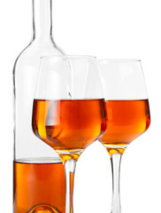 Bottle and glasses of tasty wine on white background