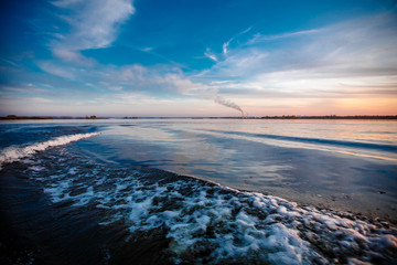 Deep river. Crossing from coast to coast. Very beautiful path on the water behind the stern of the boat from the engine.