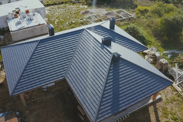 Corrugated metal roof and metal roofing. Modern roof made of met - obrazy, fototapety, plakaty