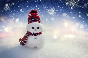 Merry snowman standing in a winter night Christmas landscape. Merry Christmas and Happy New Year Greeting Card