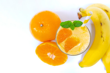 Orange mix banana smoothies yellow fruit juice milkshake blend beverage healthy high protein the taste yummy In glass,drink to lose weight drink episode morning on white  background from top view.