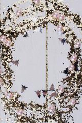 Christmas frame from glitter particles and beads. Magic decorative ring. Space for text.