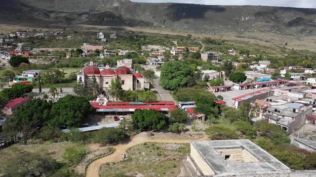 Beautiful Church San pablo villa de mitla with beautiful red roof , street market and pyramid archeological site in Oaxaca. Aerial drone view of Mexico.