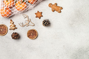 Eco christmas concept, clementines in cotton mesh bag, wooden ornaments, pinecones, gingerbread