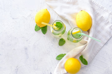 Bottles of tasty lemonade on white background