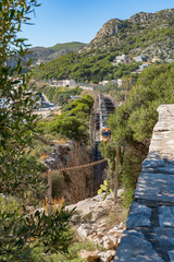 Moving train in a mountain gorge. Garraf. Spain. 26 nov 2019
