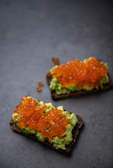 Avocado Toast on Rye Bread Topped with Salmon Ikura