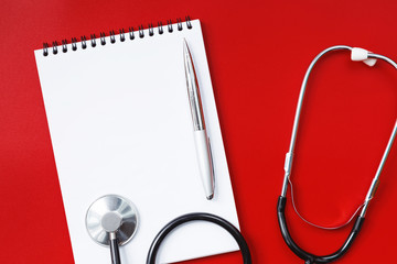 Stethoscope on a red table, concept medicine