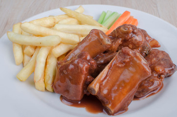 ribs in bbq sauce, french fries and salad