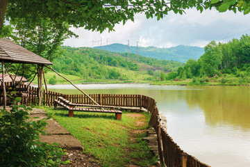 Fototapeta premium place for rest on the shore of mountain lake. beautiful nature scenery in spring time.place for rest on the shore of mountain lake. beautiful nature scenery in spring time.