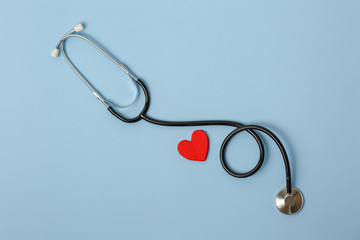stethoscope on a blue background with a red heart