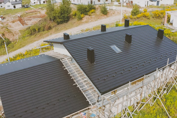 dark gray roof of an industrial building made of metal. Corrugat