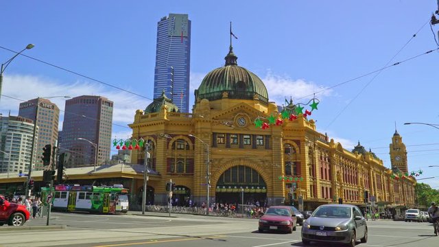Timelapse of passengers srossing the road in front of the Melbourne Flinders Street Station
