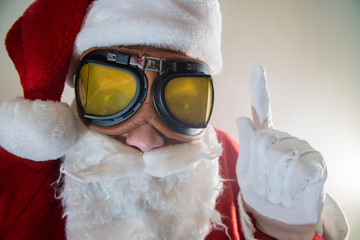 Portrait of bearded old man in Santa costume having fun comic grimace