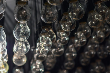 Retro light bulbs background as decoration. Selective focus. Low DOF. Toned image.