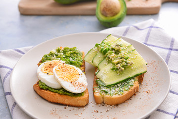 Tasty avocado sandwiches on plate