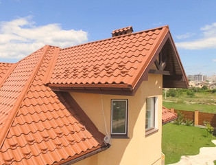 House with a new roof made of orange metal. View from above. Cor