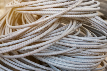close up pile of deformed bar steel rods in stock at a construction warehouse. Deformed bars are widely used in construction industry.