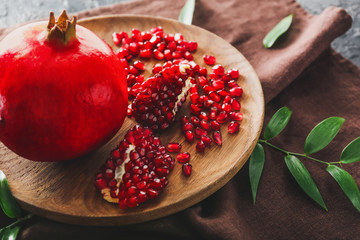 Plate with tasty pomegranate on table