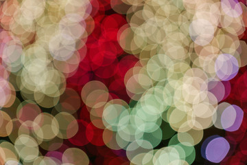 Gold, red and purple Christmas light shiny abstract round bokeh on dark background. Colourful Glitter bokeh from blurry decoration bulbs.
