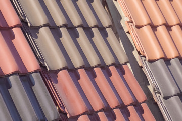 Samples of ceramic roofing tiles in a warehouse of a roofing mat