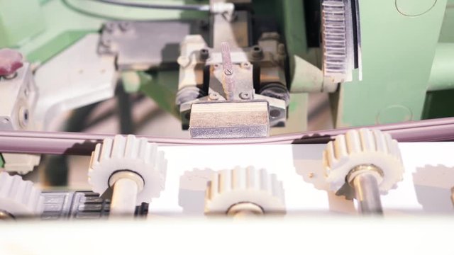 Close-up of automatic belt sander, modular bead sticking machine. Action. Production of complex parts on the coordinate boring machine with CNC.