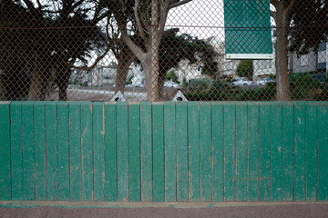 green fence at the park back of baseball diamond