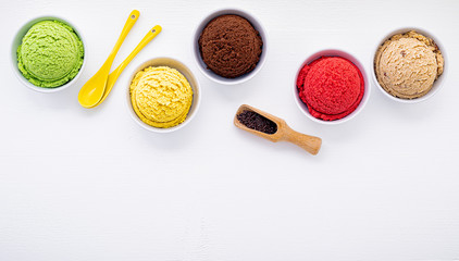Various of ice cream flavor ball blueberry ,lime ,pistachio ,almond ,orange ,chocolate and vanilla set up on white wooden background . Summer and Sweet menu concept.