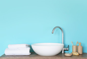 Fototapeta premium Soft towels and cosmetics near bathroom sink