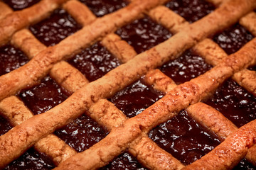 Close-up of a warm homemade Pasta Frola tart filled with quince and apple jelly. Argentinian Pastafrola Recipe.