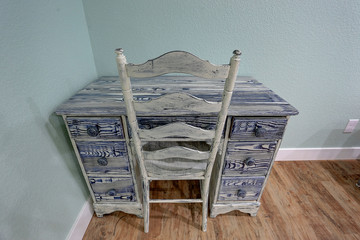 Blue childs desk, and chair on wood floor
