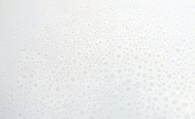 many small drops of water on the white surface