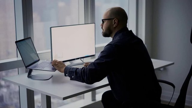 Millennial man doing online browsing during web work with revenue statistics or crypto currency chart, businessman checking banking commerce for analyzing 