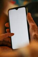 Old woman holding smart phone for shpping online