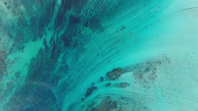 Le Morne underwater waterfall at Mauritius with turquoise sea water aerial background
