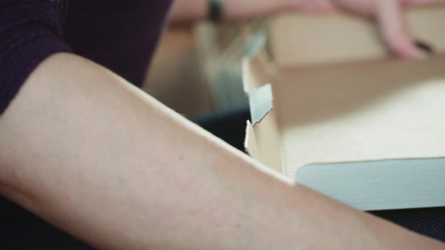 women manually make cardboard boxes